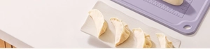 Detailed view of purple silicone baking mat with measurement scales and fresh dumplings