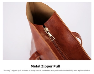 Close-up of durable golden polished metal zipper on vintage brown leather tote bag