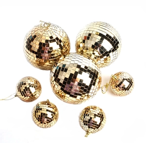 Detailed close-up of golden mirror disco balls for Christmas tree decoration with hangers