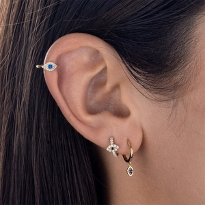 Detailed close-up of Evil Eye ear cuff and blue zircon earrings set worn on ear
