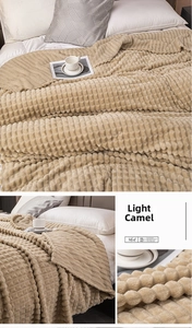 Dettaglio della coperta in velluto color cammello chiaro con trama a nido d'ape