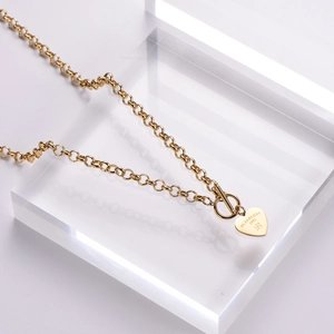 Golden double-layer chain necklace featuring heart pendant and OT toggle clasp closure