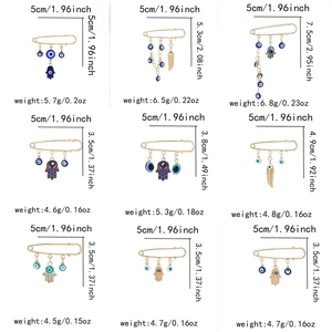 Size and weight specifications for gold evil eye tassel pins and hand of fatima brooches