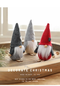 Three Christmas gnomes with ski poles and wooden skis in a rustic holiday tray display