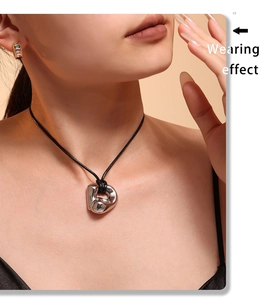 Wearing effect of a silver irregular abstract pendant on a black adjustable cord necklace