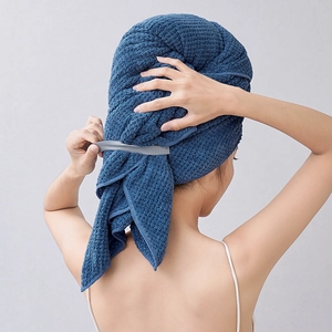 Detail of dark blue pineapple grid microfiber hair towel wrap on female model