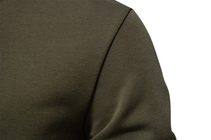 Macro shot of olive green sweatshirt shoulder seams showing durable cotton blend stitching