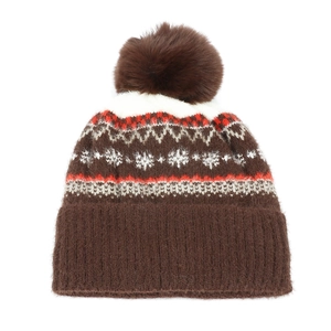 Close-up of Fair Isle snowflake knit pattern and fluffy brown faux fur pompom on winter hat