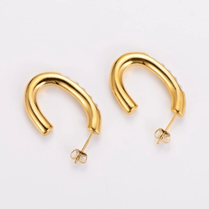 French minimalist U-shaped gold earrings with inlaid pearls on a clean white background