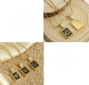 Detail view of square 18K gold titanium steel necklace with natural shell inlay charms