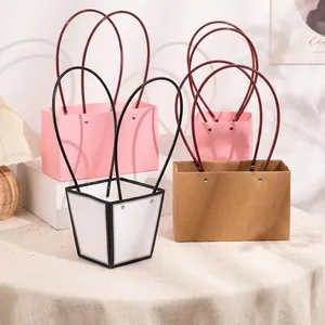 Minimalist paper flower gift bag with slender handles in pink and white marble textures