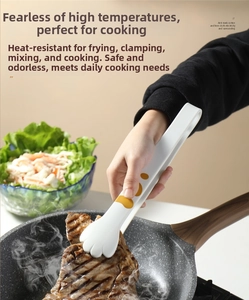 Heat-resistant silicone cat paw food tongs flipping a steak in a frying pan
