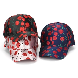 Detailed embroidery view of cherry pattern on black, pink, and navy baseball caps