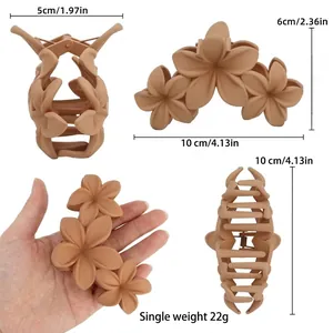 Matte floral claw clip for women in beige featuring a 3D five-petal flower design