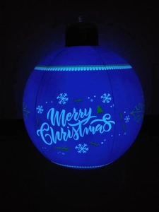 Close-up of blue LED Christmas ball with Merry Christmas text and snowflake patterns