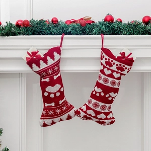 Knitted bone Christmas stockings with festive patterns on fireplace mantel decoration