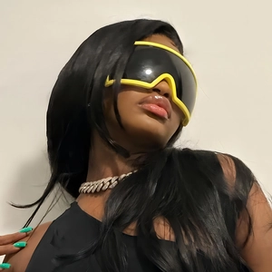 Close-up of sporty wrap-around sunglasses with yellow frames and dark lenses on a model