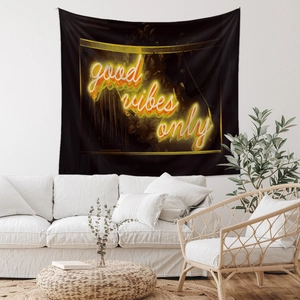 Detail showing 'Good Vibes Only' neon style lettering on a black wall tapestry