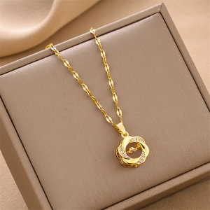 Elegant gold titanium necklace with circular interlocking pendant and zircon stone in brown box