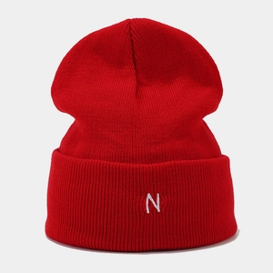 Close-up of the red ribbed knit beanie featuring a white embroidered letter N