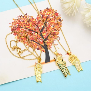 Detail of 18K gold plated Virgin Mary pendants with colorful cubic zirconia and relief