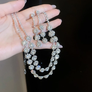 Detailed view of silver crystal double-layer flower necklace and earrings jewelry set