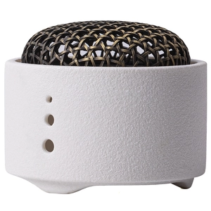 Minimalist ceramic incense burner with bronze metal woven cover and textured white base