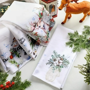 Macro shot of microfiber Christmas kitchen towels with festive reindeer and snowman prints