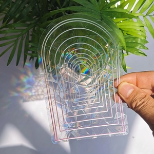 Rainbow suncatcher window film with geometric arch pattern casting colorful light