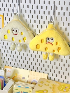 Close-up of plush triangle cheese coin purses with cute embroidered faces and small legs