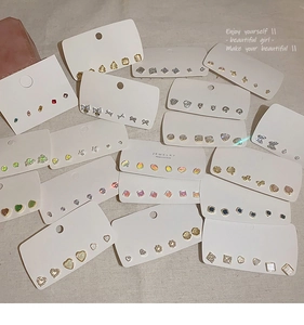 Detail of 925 silver needle bow earring sets with pearls and crystals on display cards