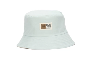 Detail view of mint green bucket hat with H&Q leather patch and reinforced stitching