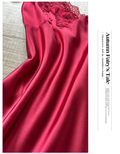 Close-up of elegant burgundy silk bathrobe with delicate lace embroidery details