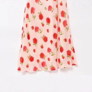 Floral sleeveless maxi dress with pink rose print and ruffled hem detail in summer chiffon