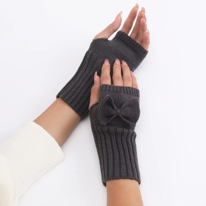 Detailed knit texture of dark grey fingerless gloves with a decorative bow accent