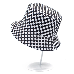 Checkered reversible bucket hat with wide brim on a display stand for sun protection