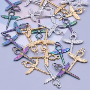 Macro shot of dragonfly pendants in gold, silver and iridescent finishes for DIY jewelry