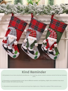 Close-up of three hanging Christmas stockings with gnome figures on a white fireplace