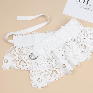 Detailed shot of white floral embroidery lace with elastic band and silver D-ring buckle