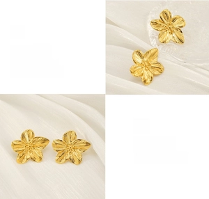 Detailansicht goldener Blütenohrstecker mit polierter Oberfläche und floraler Textur