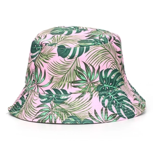 Close-up of pink bucket hat featuring green tropical leaf prints and fine stitching detail