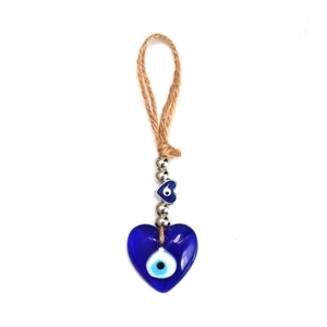 Detailed view of heart-shaped blue evil eye charm with jute rope and silver beads