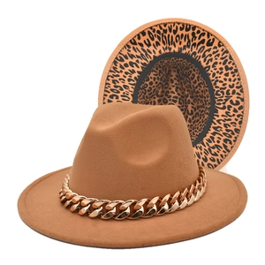 Macro detail of camel felt fedora with gold chain link and leopard print lining