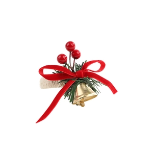 Christmas napkin ring with red velvet bow, pine needles and golden bell on a white background