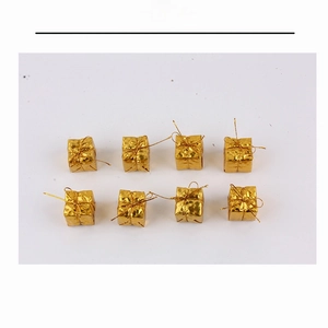 Detail of 8 gold mini Christmas gift boxes with shiny foil wrap and metallic bows