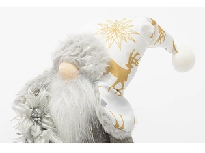 Close-up of plush Christmas gnome showing snowflake print hat and soft faux fur beard