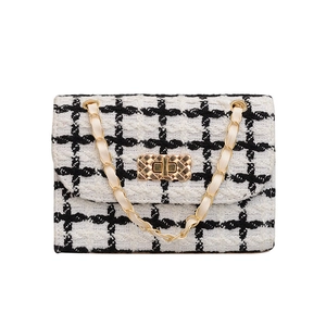 Classic black and white tweed crossbody chain bag with golden rectangular turn lock buckle