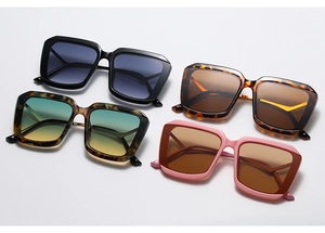 Detailed overhead view of oversized square sunglasses in black, tortoiseshell, and pink