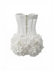 Detail of white mesh corset dress with sheer fabric and 3D floral petal hem design