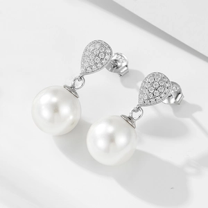 Macro detail of S925 sterling silver stamp on water drop pearl earrings with cubic zirconia